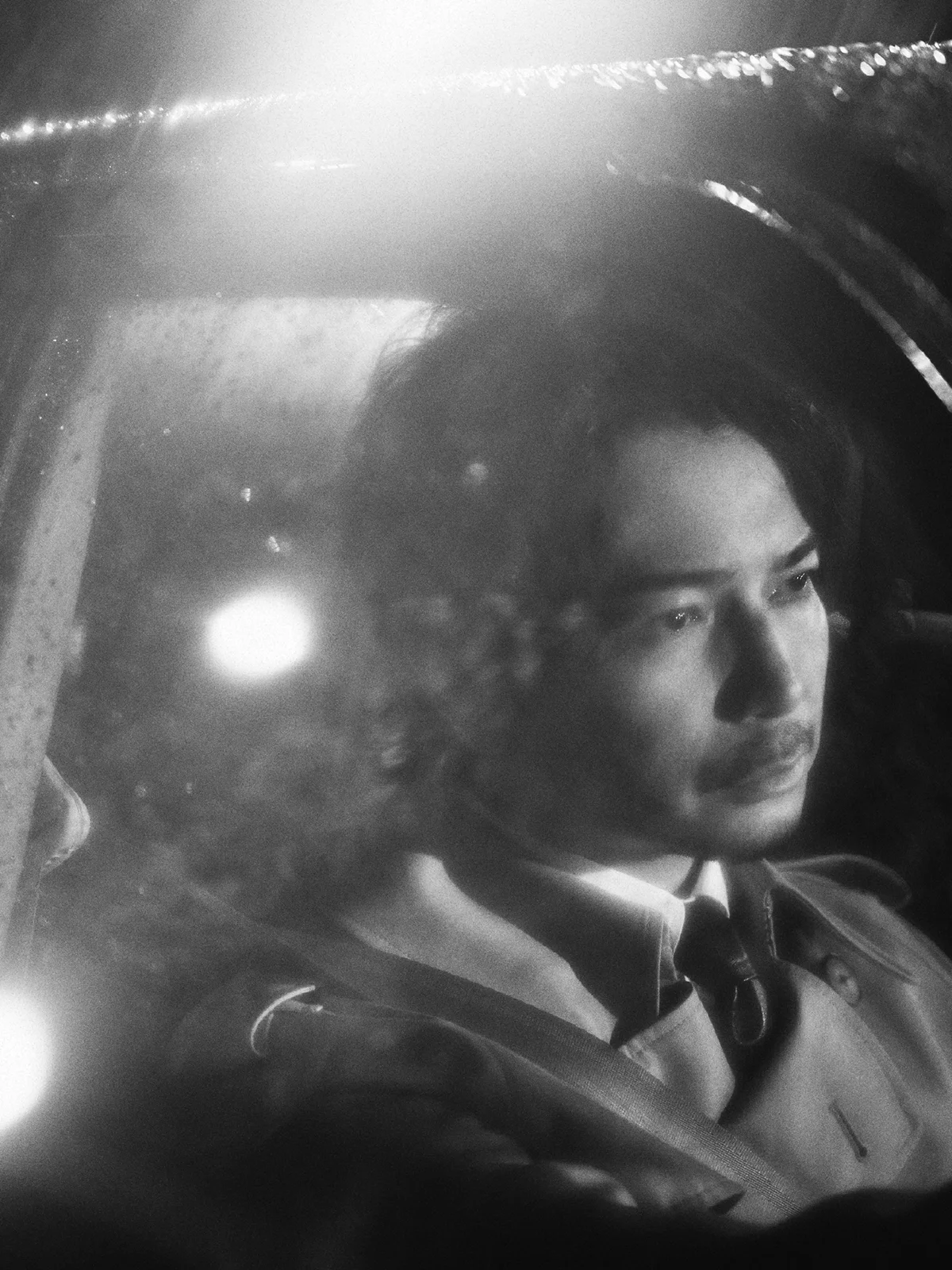 Jun Matsumoto seated inside a car